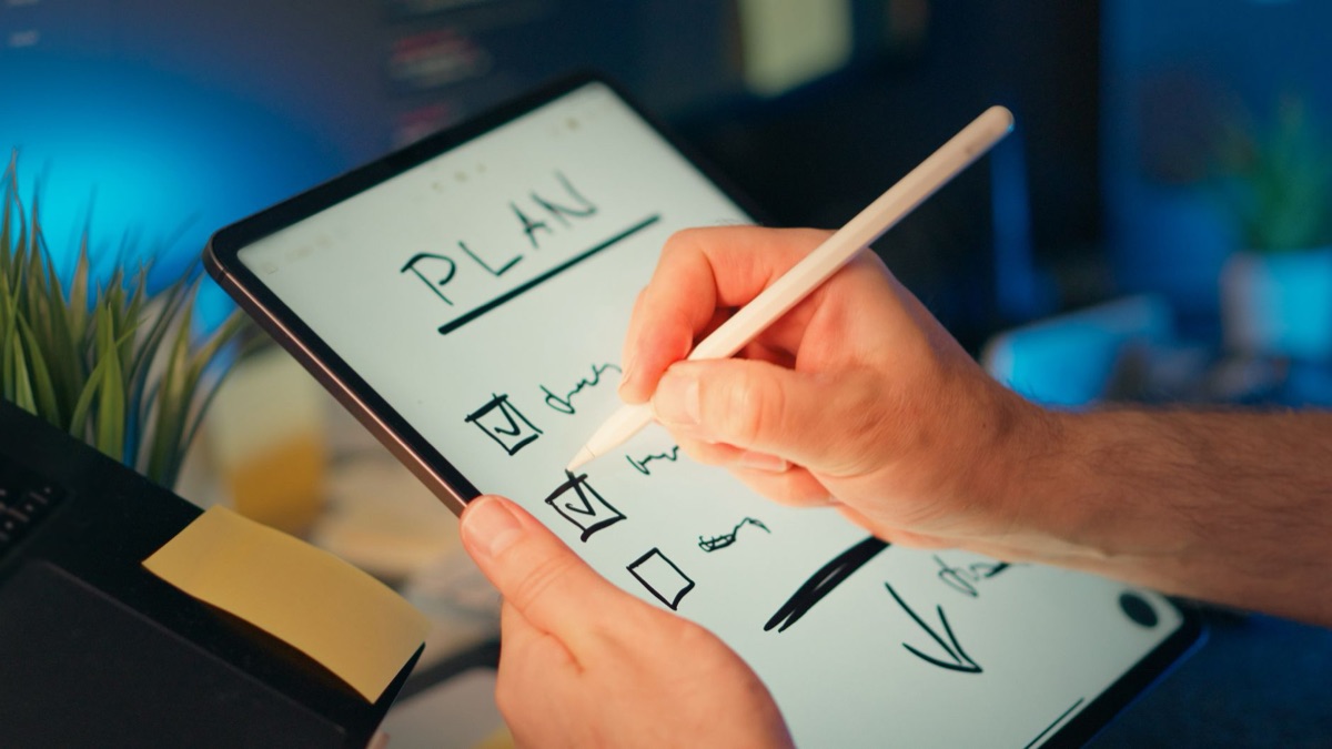 Un ingénieur vérifie une liste de contrôle sur une tablette.