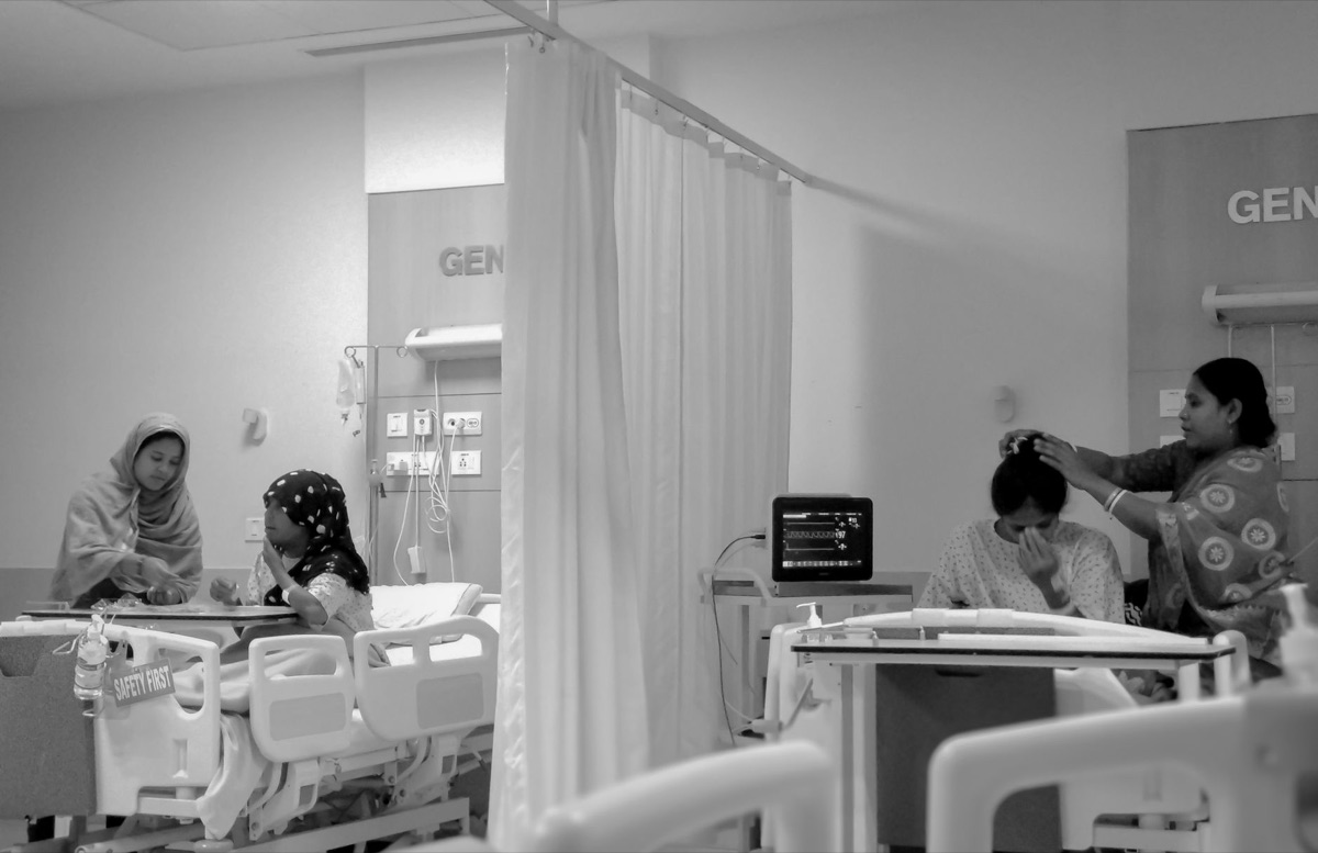 Family member at hospital monitor with vital signs