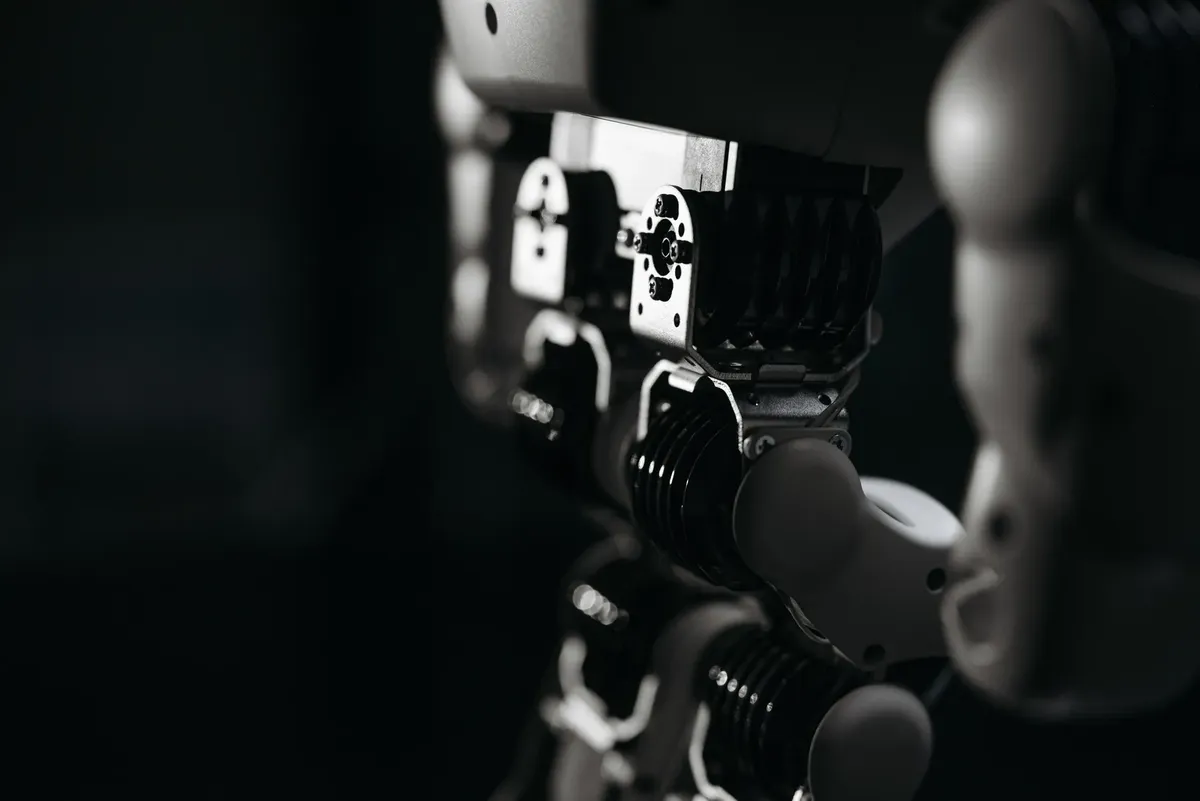 Detailed close-up of a robot's mechanical components, emphasized by moody studio lighting.